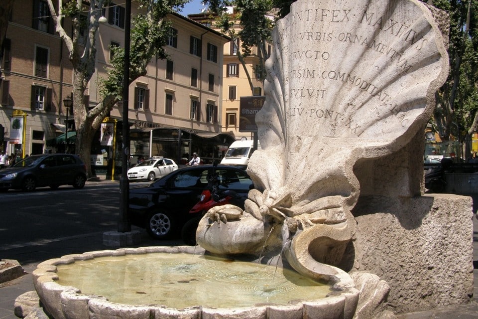 The Bernini Bee Fountain is located next to Piazza Barberini in Rome.